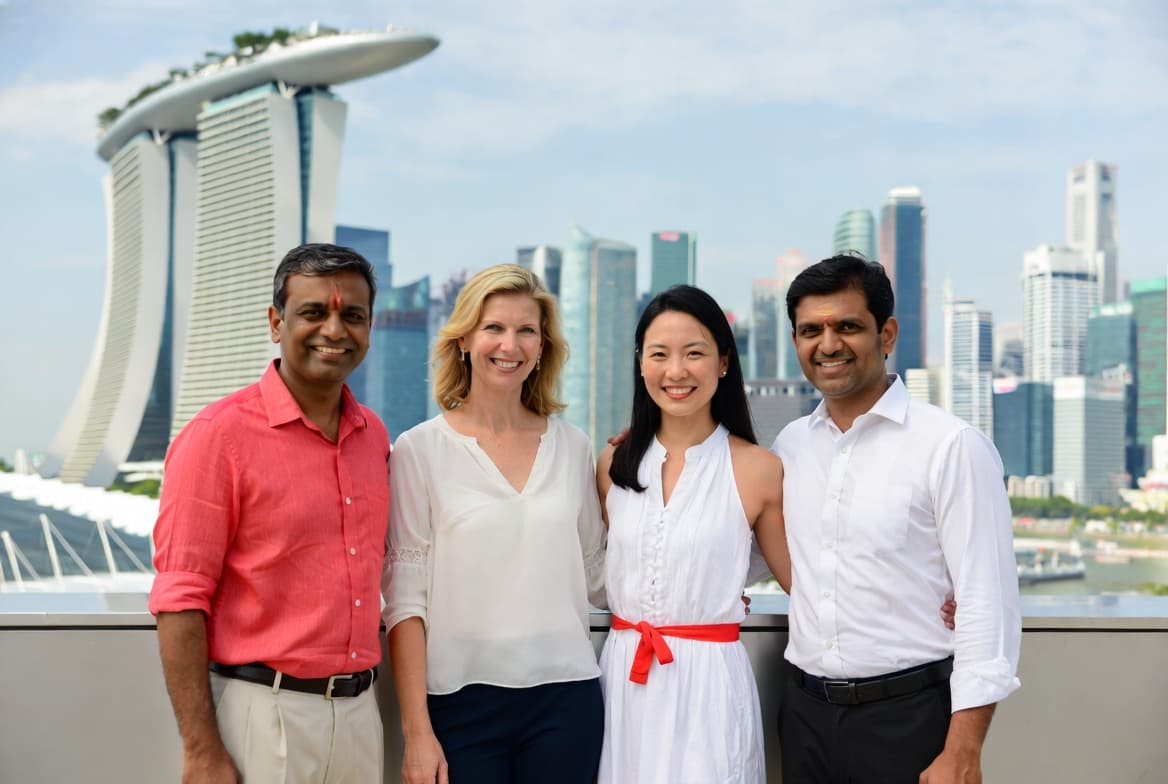 Diverse group of expat professionals in Singapore with Marina Bay Sands in the background